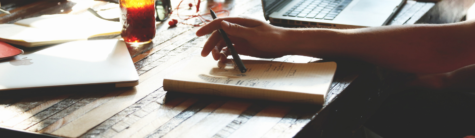 notebook and pen in hand