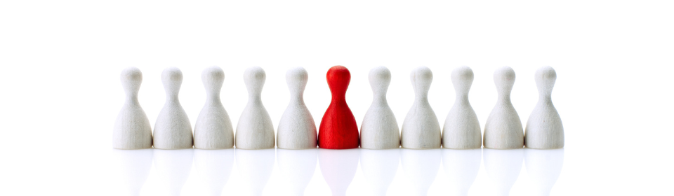 white chess pieces with one red piece
